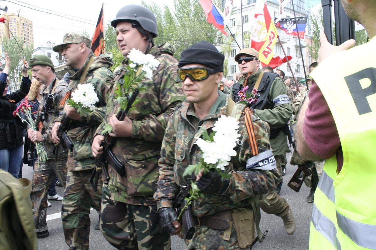 Plötzlich marschiert am Rande der prorussischen Kundgebung eine Abordnung schwer bewaffneter Kämpfer auf.