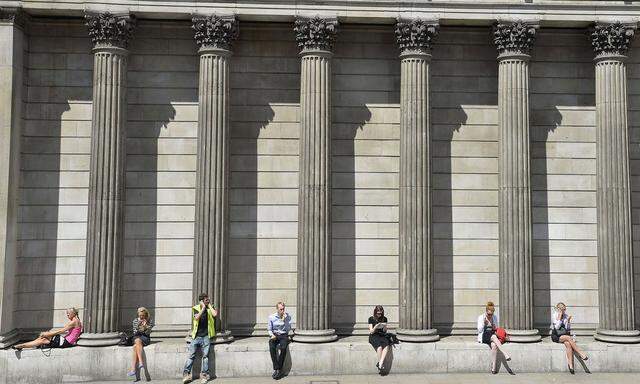 File photo of workers relaxing during the lunch hour outside the Bank of England in the City of London