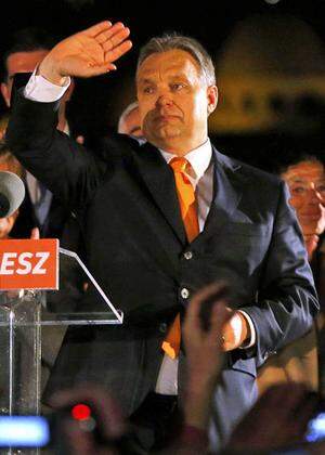 Hungary´s PM Orban waves hand as he addresses to supporters after partial results of parliamentary elections are announced in Budapest