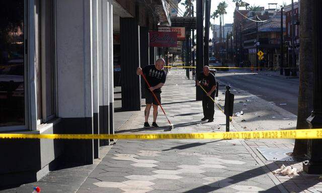 TAMPA, FLORIDA - OCTOBER 29: People clean up after a fatal shooting in the Ybor City neighborhood on October 29, 2023 in Tampa, Florida. According to reports, two people from two different groups opened fire as hundreds of people were on the street early Sunday morning in an area filled with bars and clubs.   Octavio Jones/Getty Images/AFP (Photo by Octavio Jones / GETTY IMAGES NORTH AMERICA / Getty Images via AFP)