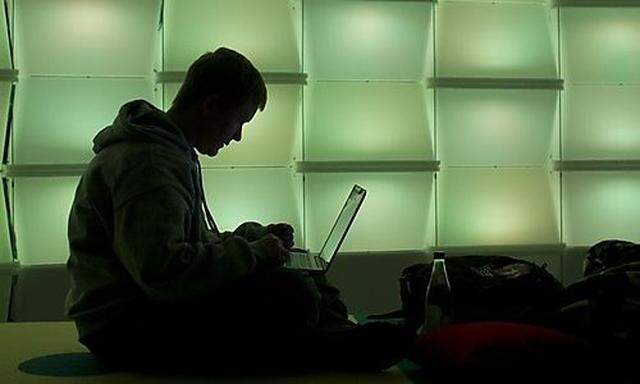 Woman uses computer in lounge area of Chaos Communication Congress (25C3) in Berlin