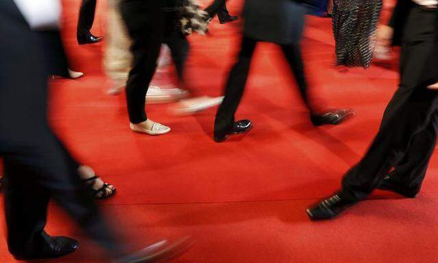 Guests walk on the red carpet as they arrive for the screening of the film 'Tale of Tales' in competition at the 68th Cannes Film Festival in Cannes