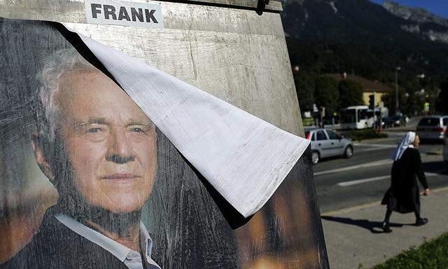 A nun passes an election poster of Austro-Canadian businessman and billionaire Stronach in the western Austrian city of Innsbruck