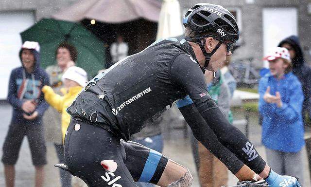 Team Sky rider Froome of Britain rides in torn cycling costume after falling in the 5th stage of the Tour de France