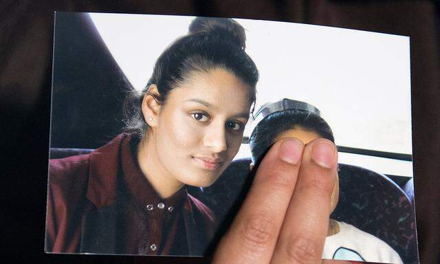 FILE PHOTO: Renu Begum, sister of teenage British girl Shamima Begum, holds a photo of her sister as she makes an appeal for her to return home at Scotland Yard, in London