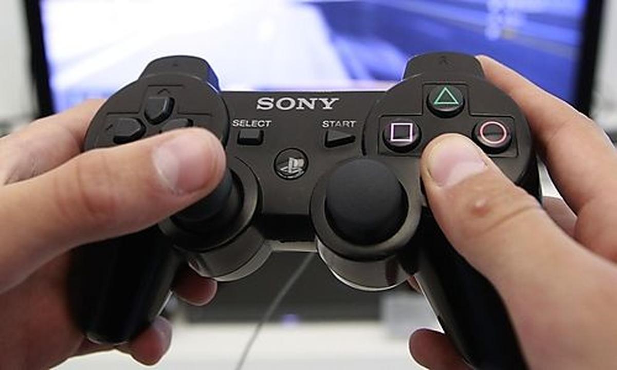 A person plays a video game at a Sony Playstation in Sony store in Berlin