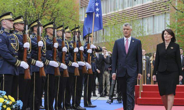 Kosovo´s new President Hashim Thaci and outgoing President Atifete Jahjaga review the guard of honor during the Presidential inauguration ceremony in Pristina