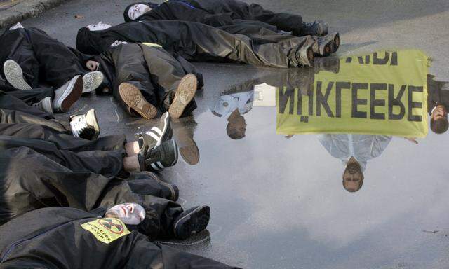 Greenpeace activists play dead in front of Energy Ministry building in Ankara