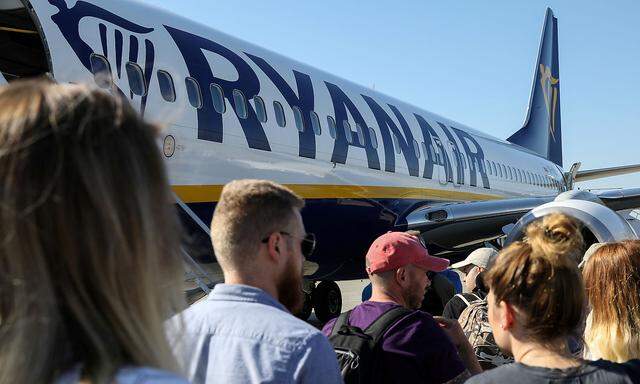 FILE PHOTO: Passengers board a Ryanair flight at the airport in Gdansk