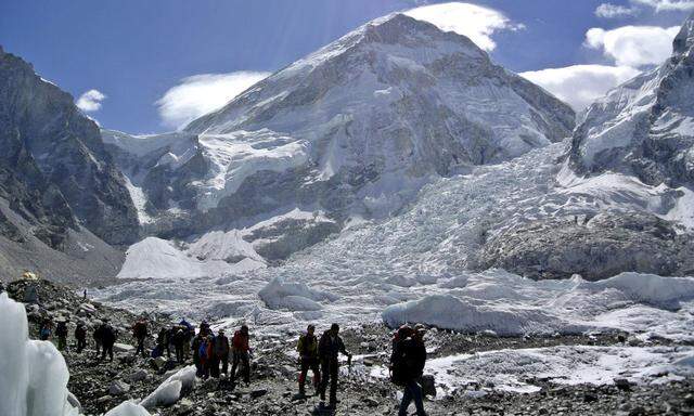 File picture shows climbers walking towards their helicopter after their Mount Everest expeditions were cancelled in Solukhumbu district, Nepal