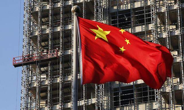 File photo of a Chinese national flag fluttering at a construction site for a new residence complex in Beijing