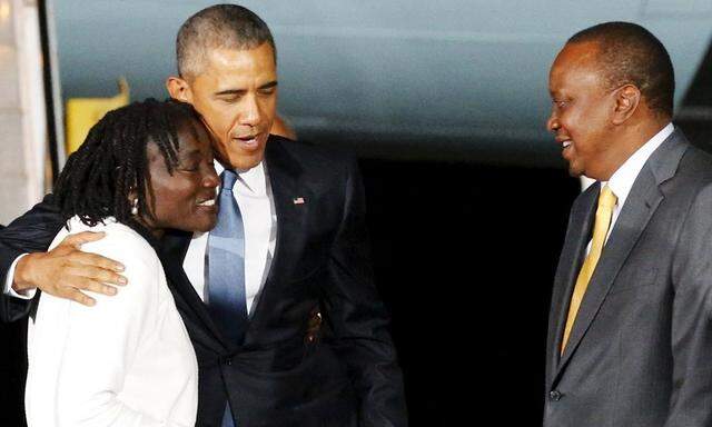 U.S. President Barack Obama embraces his half-sister Auma Obama and is greeted by Kenya's President Uhuru Kenyatta as he arrives at Jomo Kenyatta International Airport in Nairobi