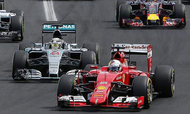 Ferrari Formula One driver Vettel of Germany overtakes Mercedes Formula One driver Hamilton of Britain at the start of the Hungarian F1 Grand Prix at the Hungaroring circuit, near Budapest