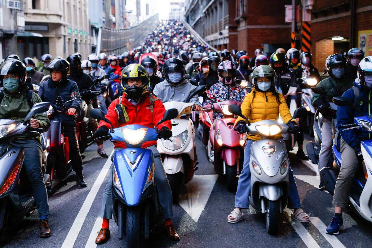 10. Jänner. Der Morgenverkeher in Taipeh. Dutzende Motorradfahrer warten auf die grüne Ampel.