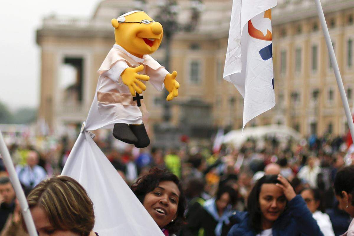 Viele Fans kommen mit Bannern oder Papst-Puppen. Auch an den 18 Großbildschirmen, die auf mehreren Plätzen in Rom aufgestellt wurden, verfolgten Zehntausende die Messe.