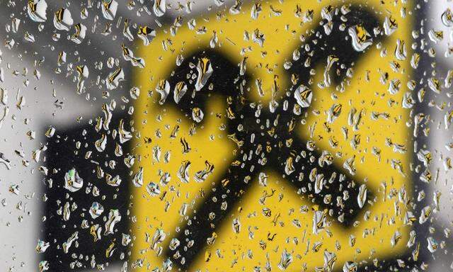 The Raiffeisen Bank International logo is pictured through raindrops at a branch office in Vienna
