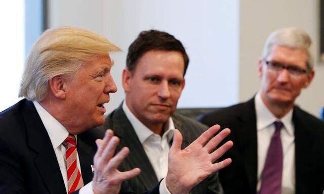 U.S. President-elect Donald Trump speaks as PayPal co-founder and Facebook board member Peter Thiel and Apple Inc CEO Tim Cook look on during a meeting with technology leaders at Trump Tower in New York