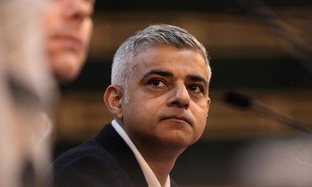 The Mayor of London, Sadiq Khan, looks on as his speech is interrupted by demonstrators at the Fabian Society New Year Conference, in central London