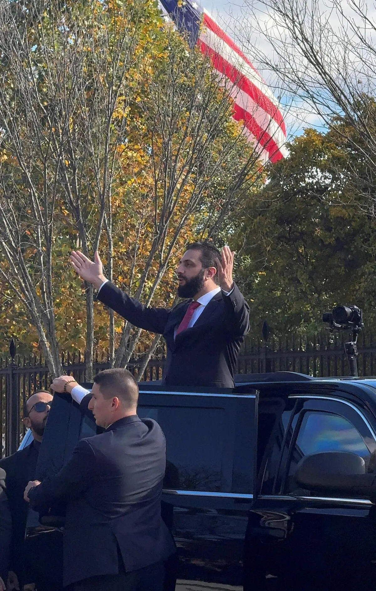 Le président syrien Ahmed al-Sharaa salue ses partisans après sa rencontre avec le président américain Donald Trump à Washington DC