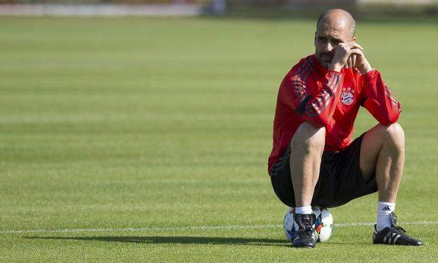 Bayern Munich's coach Pep Guardiola pauses during a training session at the club's training ground in Munich