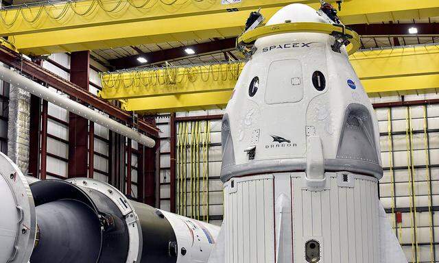 The Dragon crew capsule sits in the SpaceX hangar at Launch Complex 39-A, where the space ship and Falcon 9 booster rocket are being prepared for a January 2019 launch at Cape Canaveral