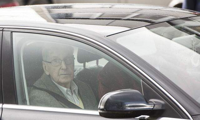 Reinhold H., a 94-year-old former guard at Auschwitz, leaves in a car after the first day of his trial in Detmold