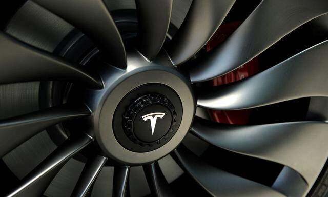 A wheel of a  prototype of the Tesla Model 3 on display in front of the factory in Sparks