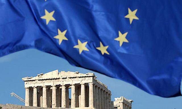 ** FILE ** A European Union flag is seen above the ancient Parthenon temple, at the Acropolis Hill in