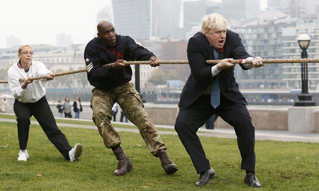 London Mayor Johnson takes part in a tug of war with members of the armed services to launch the London Poppy Day, outside City Hall, in London