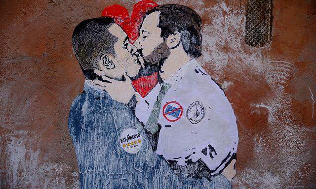 A mural depicting Northern League's leader Matteo Salvini and 5-Star Movement leader Luigi Di Maio kissing is seen in Rome