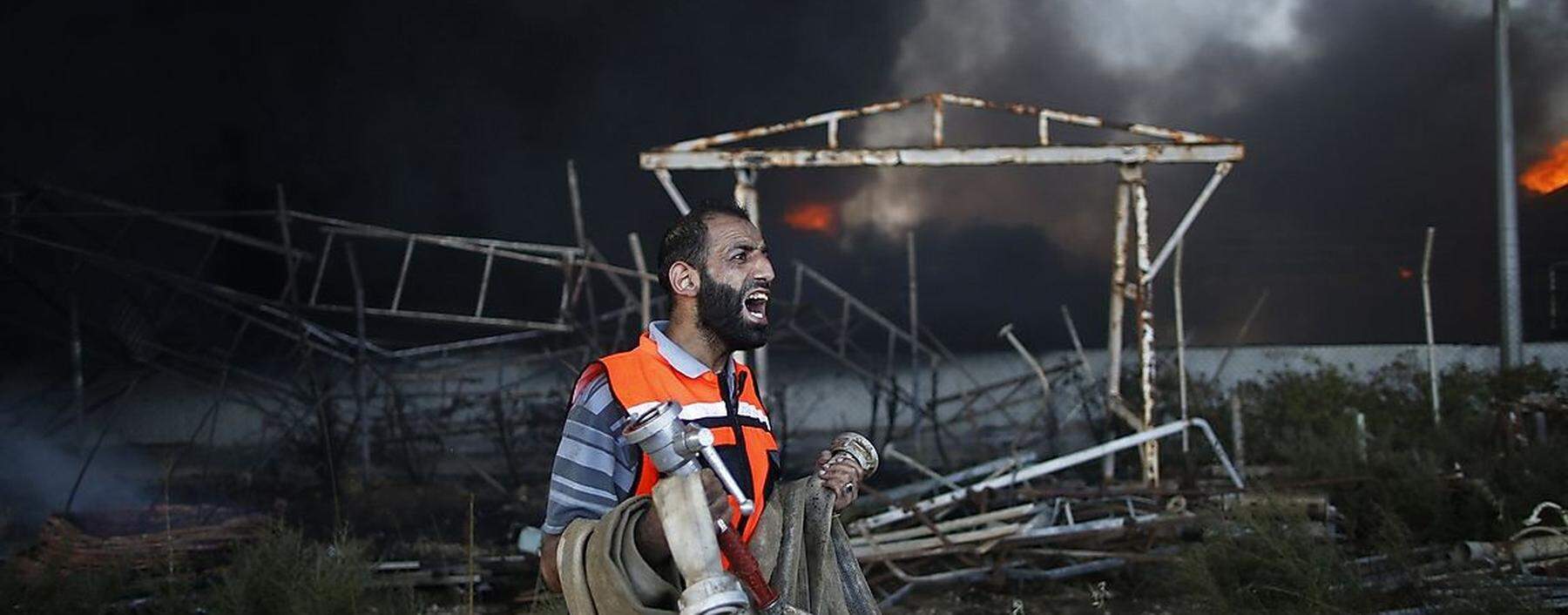 Machtlos: Ein Feuerwehrmann vor dem beschossenen Kraftwerk von Gaza