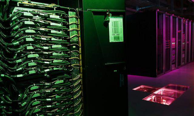 Member of the media films the room with the IBM Blue Gene Q Supercomputer on the launch day for the HBP at the EPFL in Ecublens