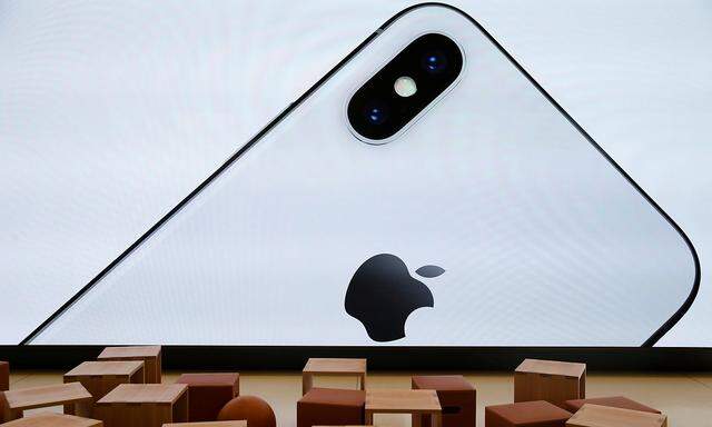 An iPhone X is seen on a large video screen in the new Apple Visitor Center in Cupertino