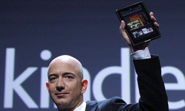 Amazon CEO Bezos holds up new Kindle Fire tablet at news conference in New York