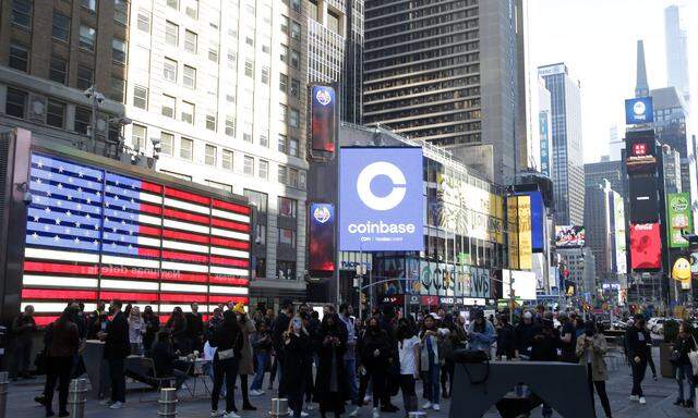 The Coinbase logo is displayed on screens in Times Square when Coinbase Global, Inc. beings trading under the symbol CO
