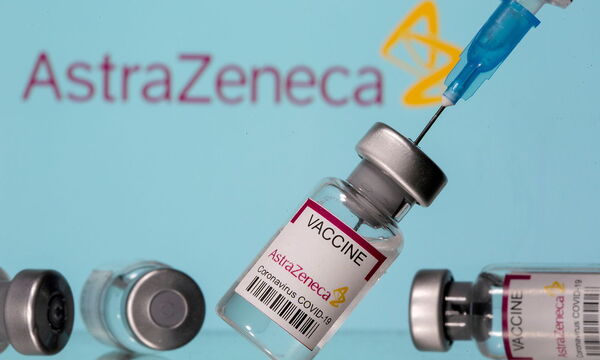 FILE PHOTO: Vials labelled 'Astra Zeneca COVID-19 Coronavirus Vaccine' and a syringe are seen in front of a displayed AstraZeneca logo in this illustration photo