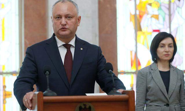 FILE PHOTO: Moldovan President Igor Dodon and Prime Minister Maia Sandu at a ceremony for swearing in new ministers in Chisinau