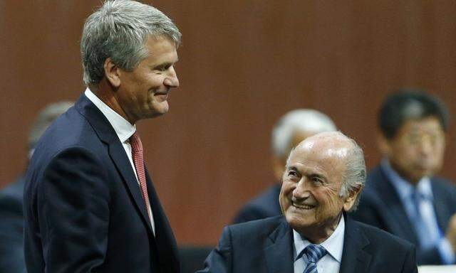 Gill of England receives his nomination at the Executive Committee from FIFA President Blatter at the 65th FIFA Congress in Zurich