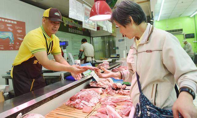 HANGZHOU, CHINA - MAY 09: A customer purchases pork at a supermarket on May 9, 2019 in Hangzhou, Zhejiang Province of C
