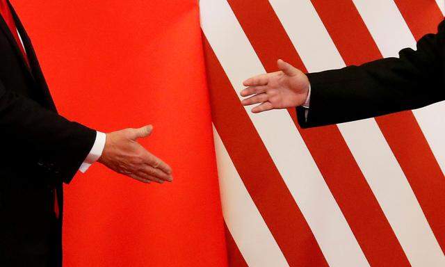 FILE PHOTO: U.S. President Donald Trump and China's President Xi Jinping shake hands in Beijing