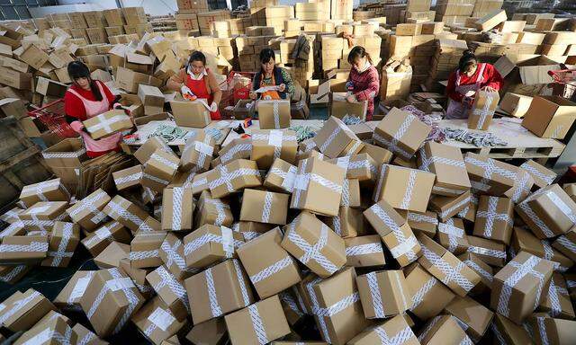 GANYU CHINA NOVEMBER 11 Workers distribute packs a logistics centre of China Post during Alibaba