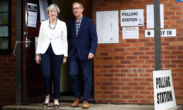 Britain´s Primer Minister Theresa May and her husband Philip leave a polling station in Sonning