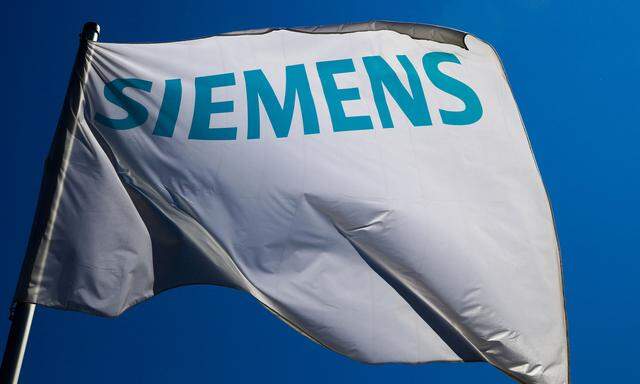 File photo of a flag with the logo of German technology firm Siemens in Berlin