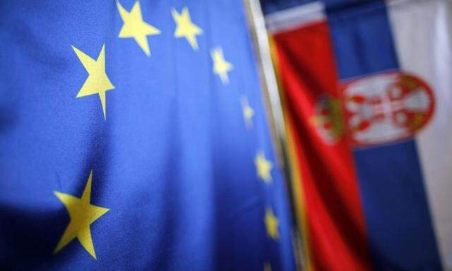 Serbian and EU flags are seen inside a shop in Belgrade in this file photo