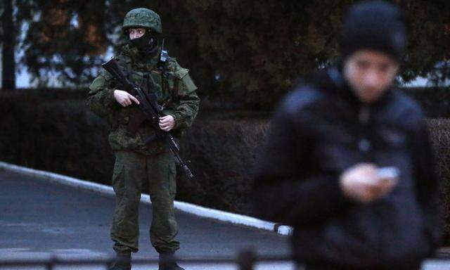 An armed man stands guard at the airport in Simferopol