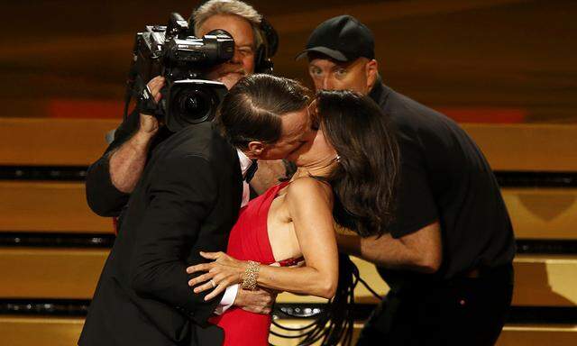 Actor Cranston engages Julia-Louis Dreyfus in a prolonged kiss as she takes the stage to accept the award for Outstanding Lead Actress In A Comedy Series for her role in HBO´s ´Veep´