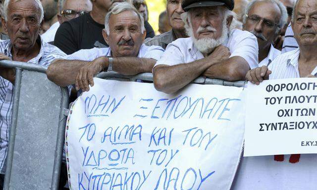 Cypriots protest against austerity measures in a demonstration outside the parliament in Nicosia