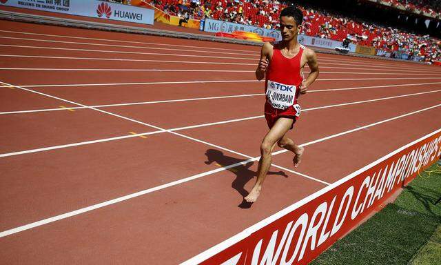 Al-Qwabani competes barefoot in his men´s 5000 metres heat at the IAAF World Championships in Beijing