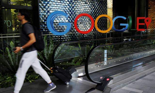 A man passes a Google signage outside their office in Singapore