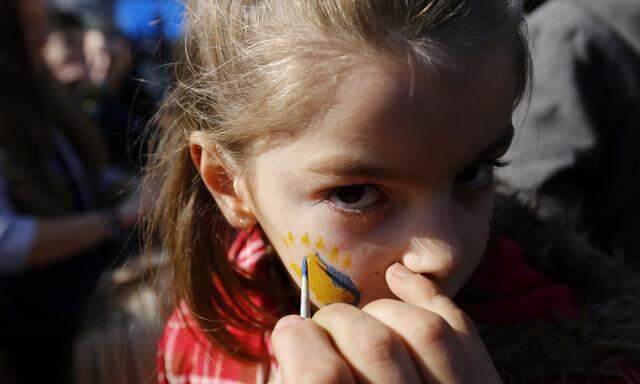 Kosovo flag is being painted on girl´s face during celebrations of the 10th anniversary of Kosovo´s independence in Pristina